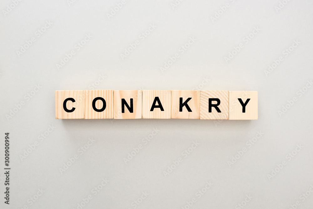 top view of wooden blocks with Conakry lettering on grey background top view of wooden blocks with Conakry lettering on grey background