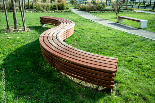 Fototapeta Naklejka Na Ścianę i Meble -  A modern bench  in a city park on a sunny day