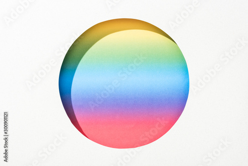 cut out round hole in white paper on bright rainbow colorful background
