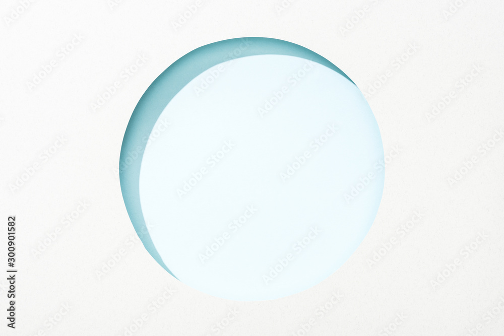 cut out round hole in white paper on light blue background cut out round hole in white paper on light blue background