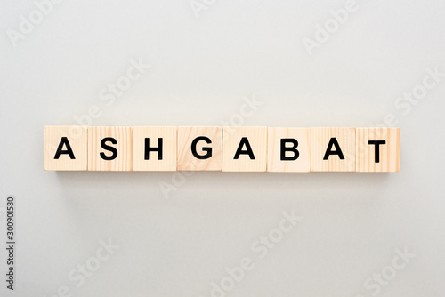 top view of wooden blocks with Ashgabat lettering on grey background