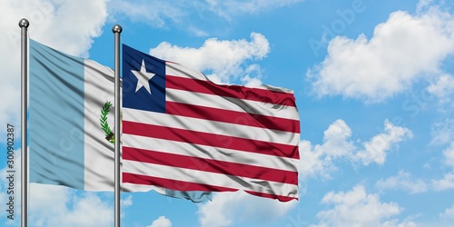 Guatemala and Liberia flag waving in the wind against white cloudy blue sky together. Diplomacy concept  international relations.