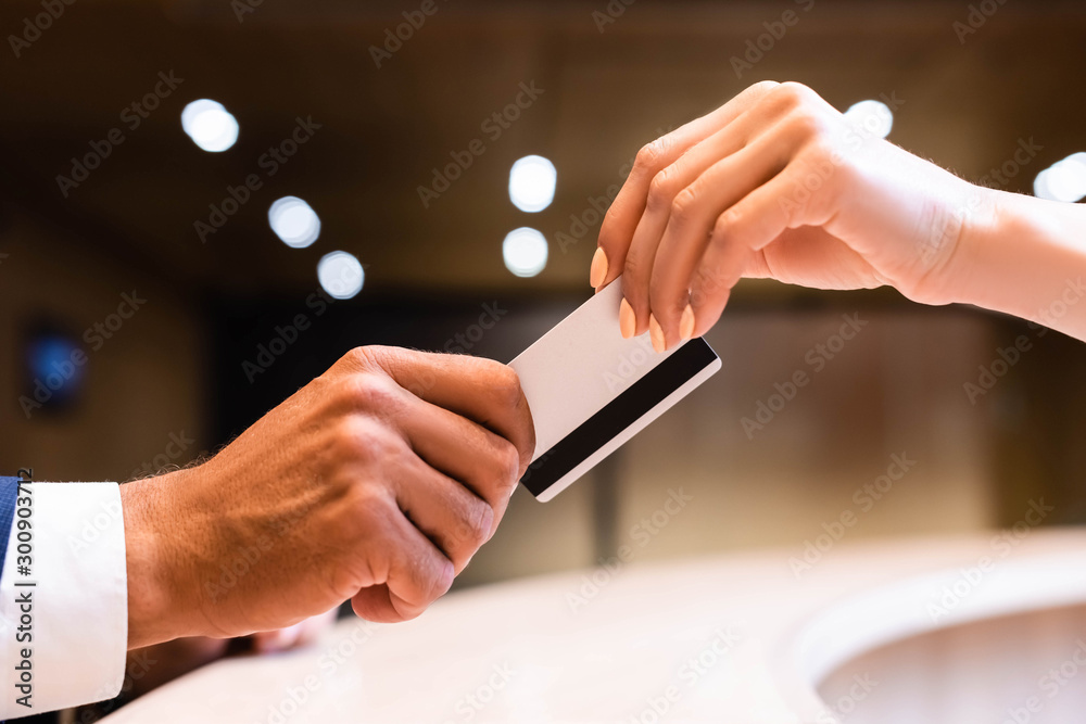 cropped view of man and woman holding credit card