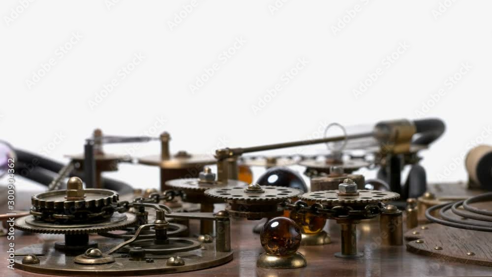 A complex mechanism with many rotating gears, chain, piston, cogs. Very similar to a clock mechanism or a working device in the old style. close-up