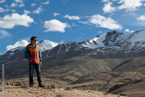 Traveler man enjoy at Tso Moriri Lake , Background is Snow top mountain, Jammu and Kashmir, India
