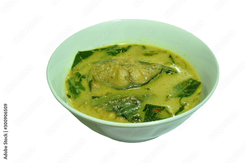spicy boiled slice catfish with basil leaf in coconut milk and curry on bowl spicy boiled slice catfish with basil leaf in coconut milk and curry on bowl