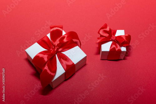 Two boxes with red ribbon and bow isolated on red. Boxing day . 