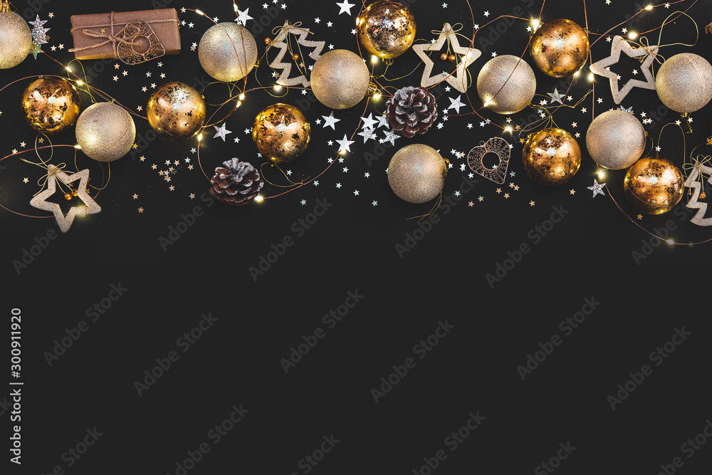 New year 2021. Merry Christmas and Happy Holidays greeting card. Christmas composition. Gold and silver decorations on black background. Winter, new year concept. Flat lay, top view - obrazy, fototapety, plakaty 