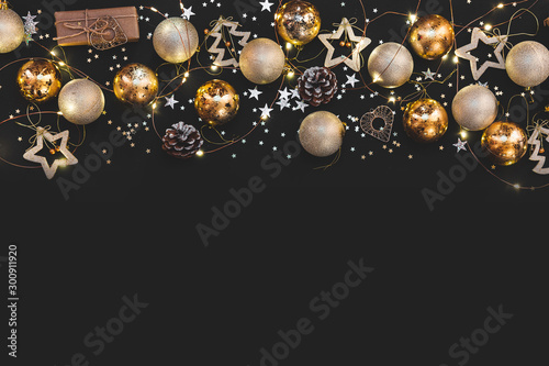 New year 2021. Merry Christmas and Happy Holidays greeting card. Christmas composition. Gold and silver decorations on black background. Winter, new year concept. Flat lay, top view