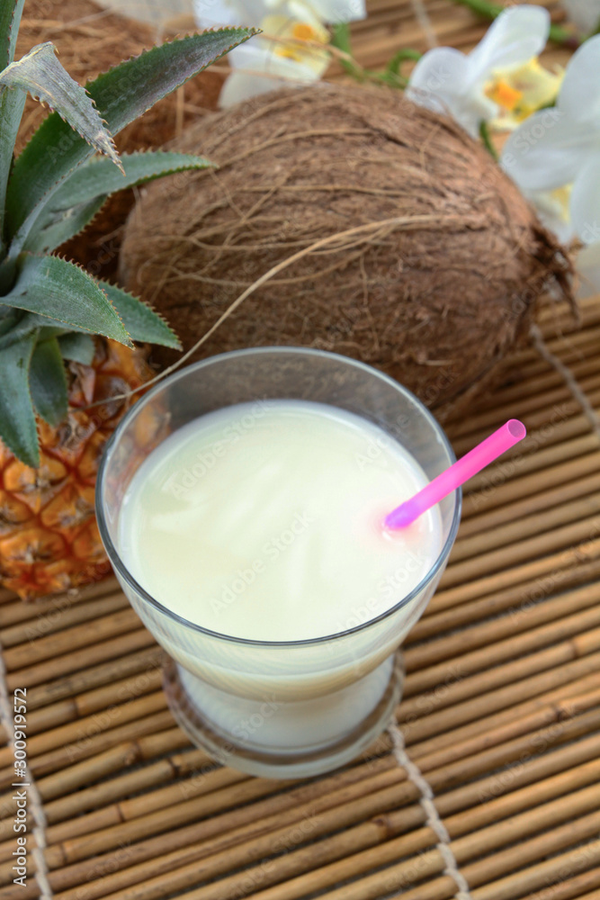 glass of pina colada cocktail on a wooden table glass of pina colada cocktail on a wooden table