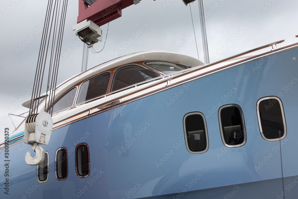 Launching of a yacht. Crane. Shipyard. Shipbuilding