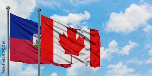 Φωτογραφία Haiti and Canada flag waving in the wind against white cloudy blue sky together