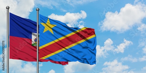 Haiti and Congo flag waving in the wind against white cloudy blue sky together. Diplomacy concept, international relations.