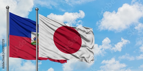 Φωτογραφία Haiti and Japan flag waving in the wind against white cloudy blue sky together