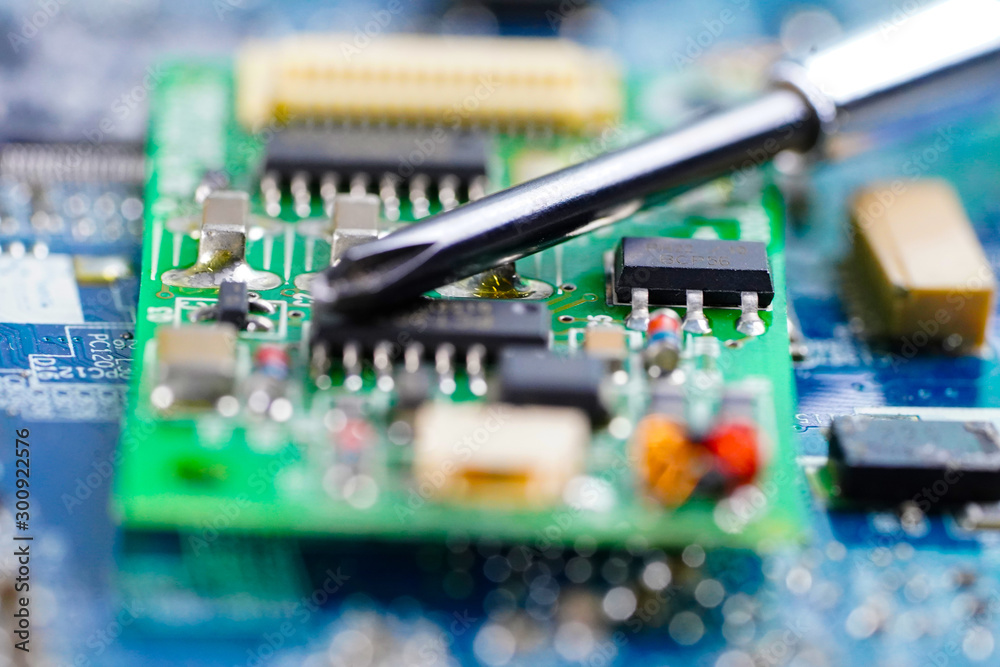 E-waste, repairing inside of hard disk by soldering iron. Integrated Circuit. the concept of data, hardware, technician and technology.. E-waste, repairing inside of hard disk by soldering iron. Integrated Circuit. the concept of data, hardware, technician and technology..