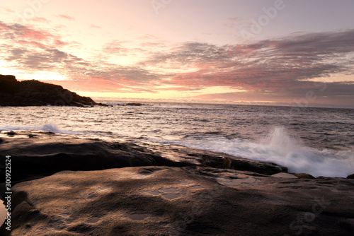 Dawn on the shore of the Atlantic Ocean. Waves crash against the rocky shore and the island in the background Atlantic Ocean. USA. Maine.  Nubble york  photo