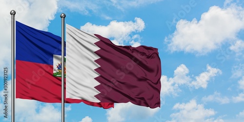 Obraz na płótnie Haiti and Qatar flag waving in the wind against white cloudy blue sky together
