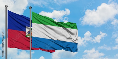 Εκτύπωση καμβά Haiti and Sierra Leone flag waving in the wind against white cloudy blue sky together