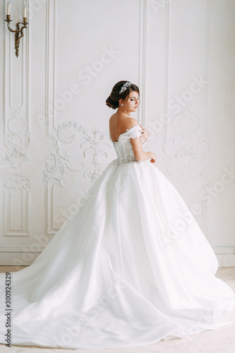 European-style wedding at the hotel. Bride in a white dress in the interior Studio. © pavelvozmischev