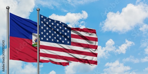 Εκτύπωση καμβά Haiti and United States flag waving in the wind against white cloudy blue sky together
