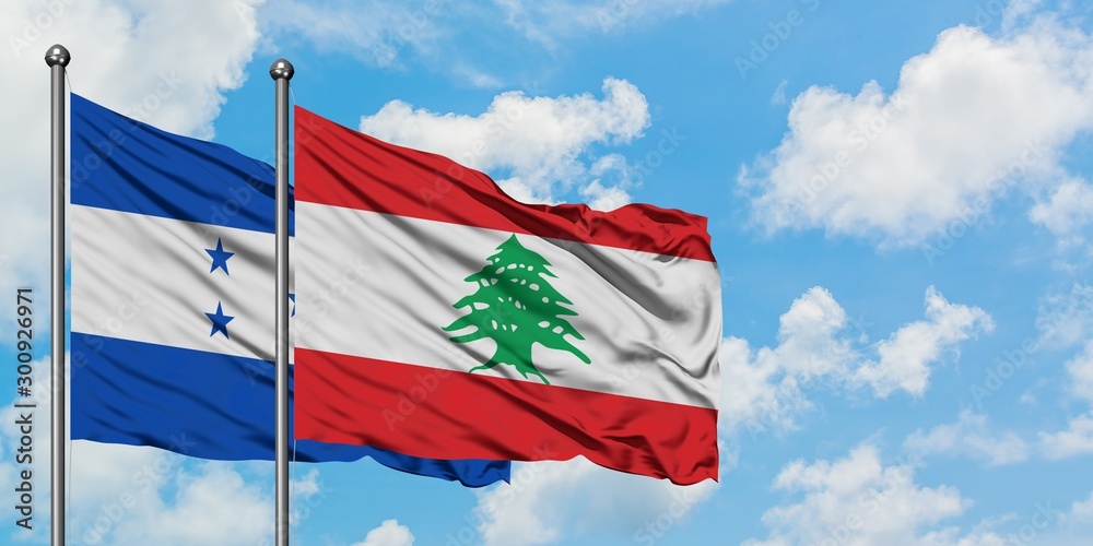 Honduras and Lebanon flag waving in the wind against white cloudy blue sky together. Diplomacy concept, international relations.