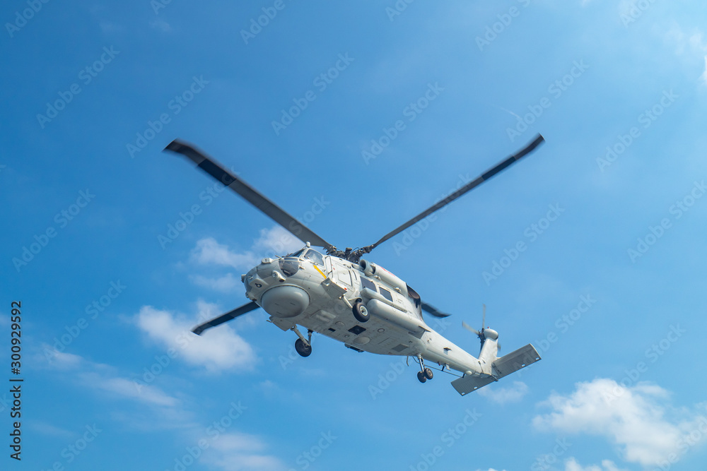 Military navy helicopter flying above the ocean.Copy space and background. Military navy helicopter flying above the ocean.Copy space and background.