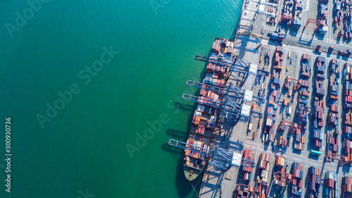 Container ship at industrial port in import export business logistic and transportation of international by container ship in the open sea.