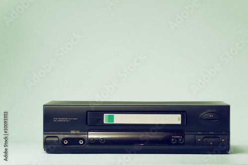 VHS video recorder Retro video recorder with video cassette on a light background film effect. photo