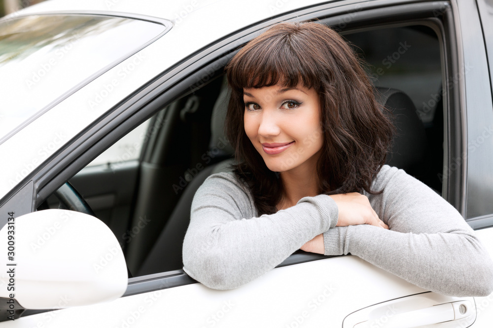 Young driver woman in white car