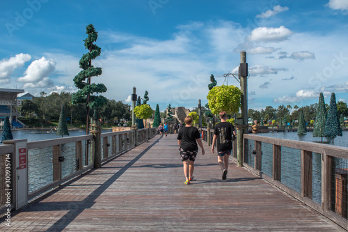 People walking on bridge and Christmas trees in blue lake 10