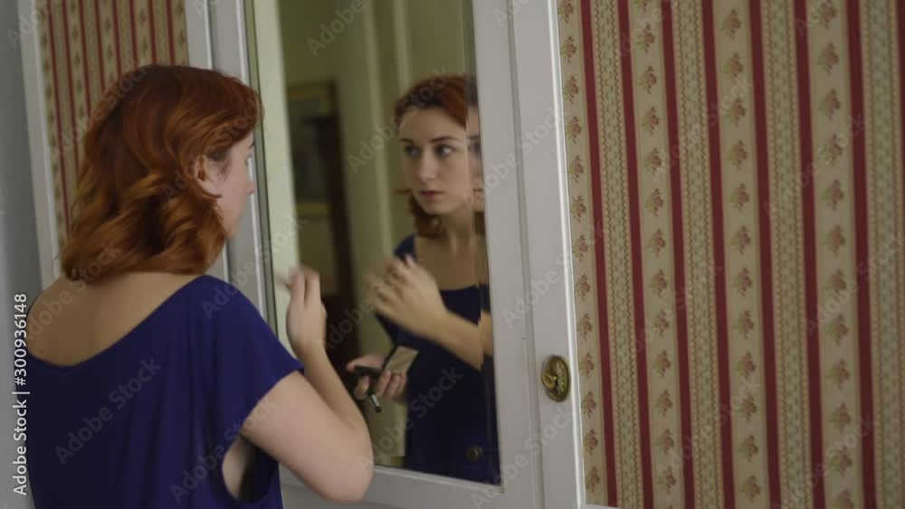 Redhead woman getting ready in the morning wearing blue home dress
