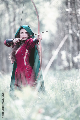 Quadro em tela An elf archer with a bow in the woods