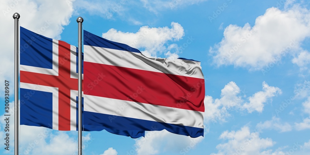 Iceland and Costa Rica flag waving in the wind against white cloudy blue sky together. Diplomacy concept, international relations.