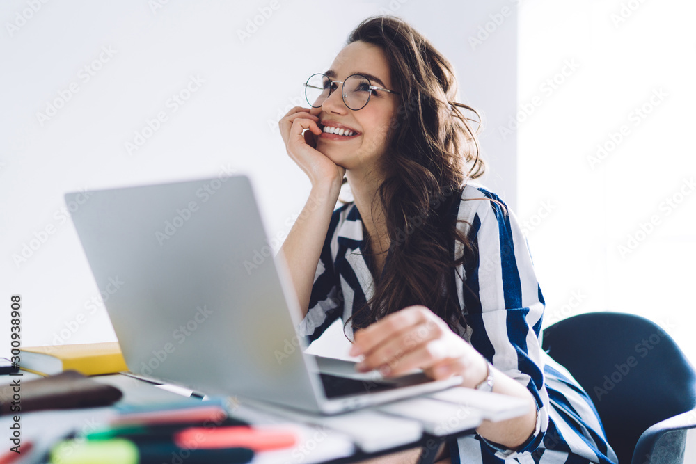 Beautiful woman with laptop smiling and thinking Beautiful woman with laptop smiling and thinking