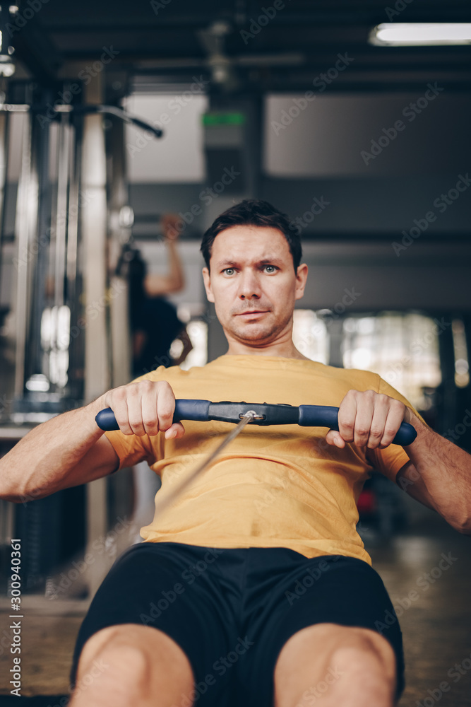 authentic image of fit attractive man working out in the gym, concept of active and healthy lifestyle authentic image of fit attractive man working out in the gym, concept of active and healthy lifestyle