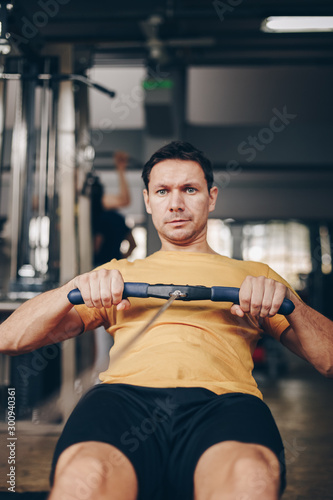 authentic image of fit attractive man working out in the gym, concept of active and healthy lifestyle