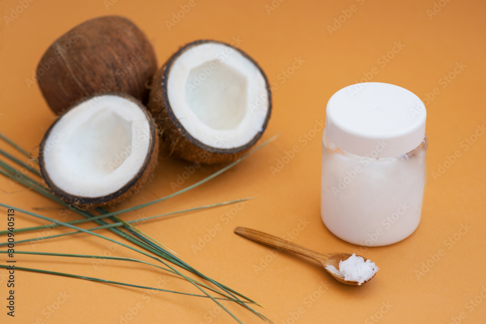 coconut oil on a poor background with coconut fruit for cosmetology and skin hydration coconut oil on a poor background with coconut fruit for cosmetology and skin hydration