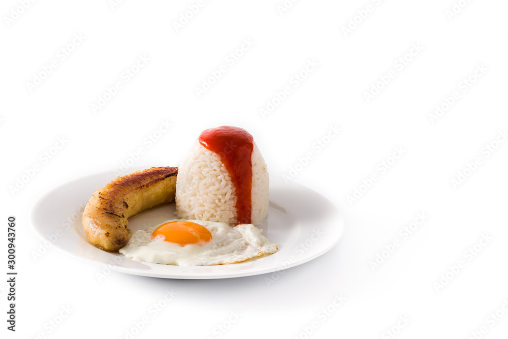 Arroz a la cubana.Typical Cuban rice with fried banana and fried egg on a plate. Copy space Arroz a la cubana.Typical Cuban rice with fried banana and fried egg on a plate. Copy space