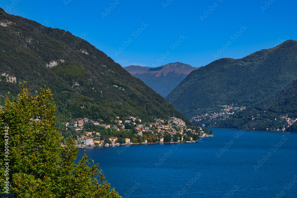Panoramic view of Lake Como. Lombardy, Italy. Autumn season. Perfect clear blue sky.