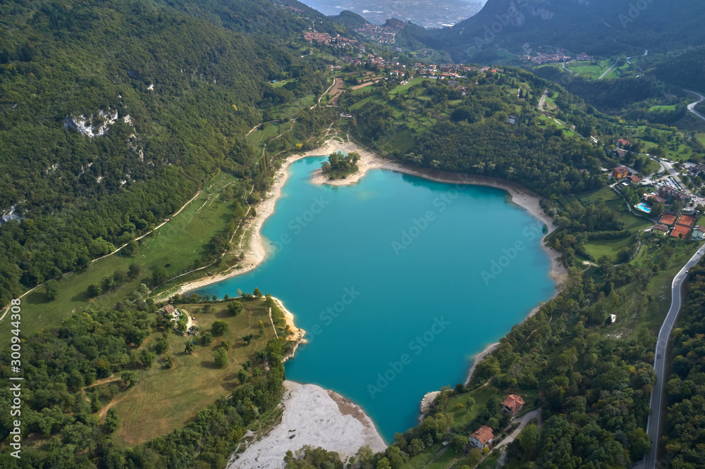 Turquoise color Lake Tenno Italy surrounded by Alpine mountains