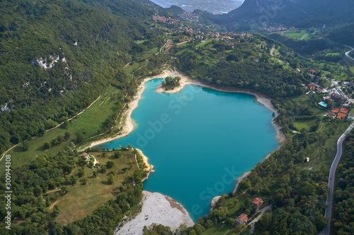 Turquoise color Lake Tenno Italy surrounded by Alpine mountains