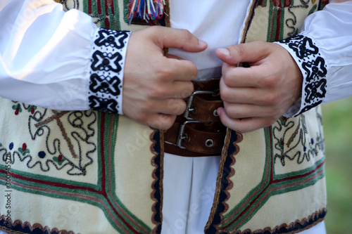 Details of men traditional Romanian folklore costume with rich emroidery.