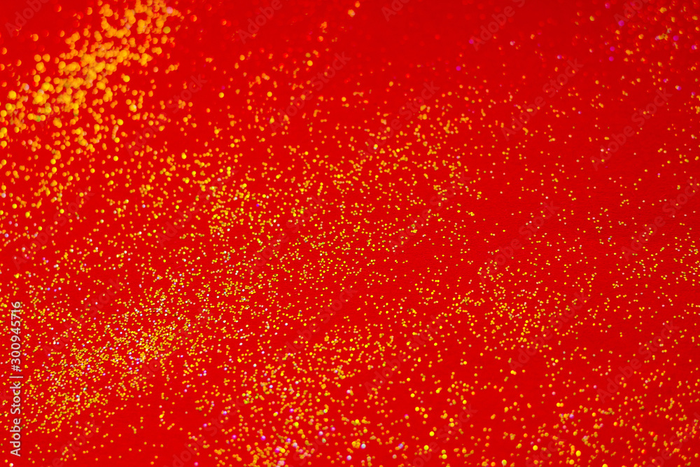 Golden sparkles on red background.