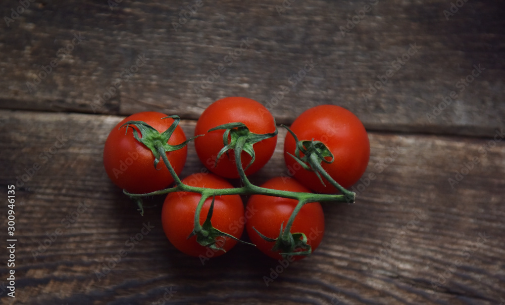 ripe red tomatoes on a green branch ripe red tomatoes on a green branch