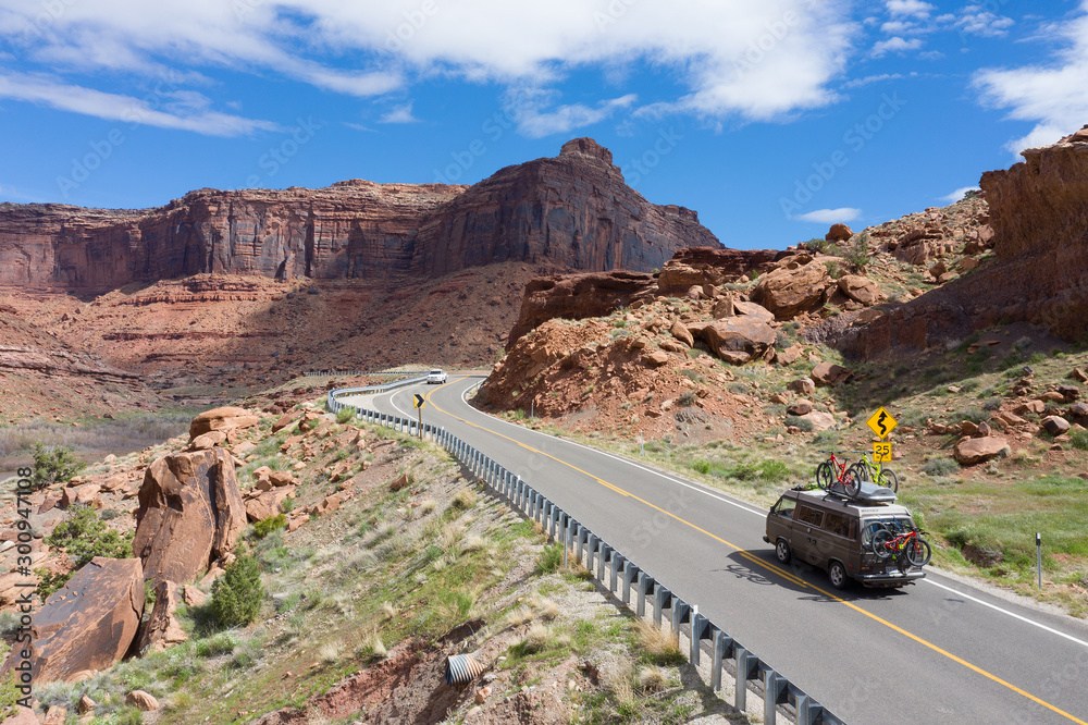 Moab, Utah, USA April 21, 2019:Camper van driving towards the mountains loaded with mountain bikes
