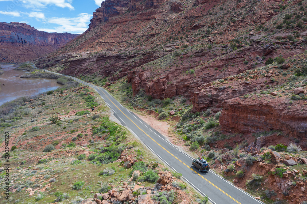 Moab, Utah, USA April 21, 2019:Camper van driving towards the mountains loaded with mountain bikes