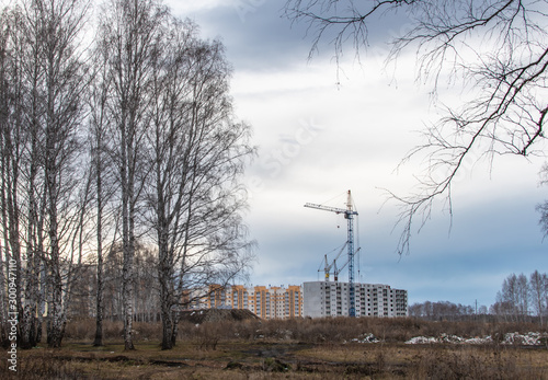 Bild auf Leinwand construction cranes on the construction site new residential area