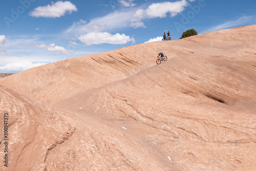 Obraz na płótnie Son, mother and grandfather riding mountain bikes of singletrack in Moab, Utah w salonie