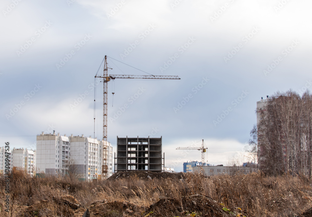 construction cranes on the construction site new residential area