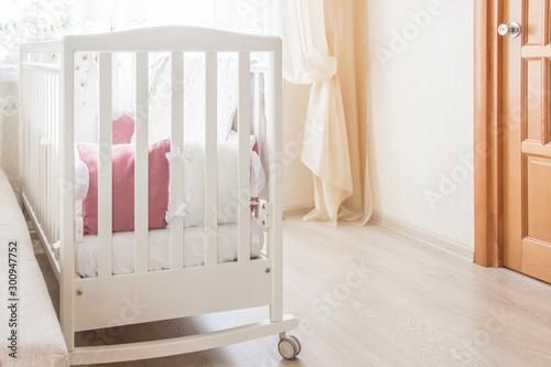 Baby bed crib with white and Burgundy color pillows with laces